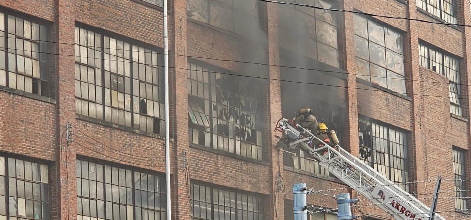 Akron firefighters battle to contain a fire in an abandoned Goodyear factory Thursday in Akron.