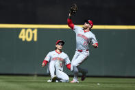 Cincinnati Reds right fielder Jake Fraley reaches and catches a fly ball with center fielder Stuart Fairchild sliding behind for an out hit by Seattle Mariners' Jorge Polanco during the seventh inning of a baseball game, Wednesday, April 17, 2024, in Seattle. The Mariners won 5-1. (AP Photo/John Froschauer)