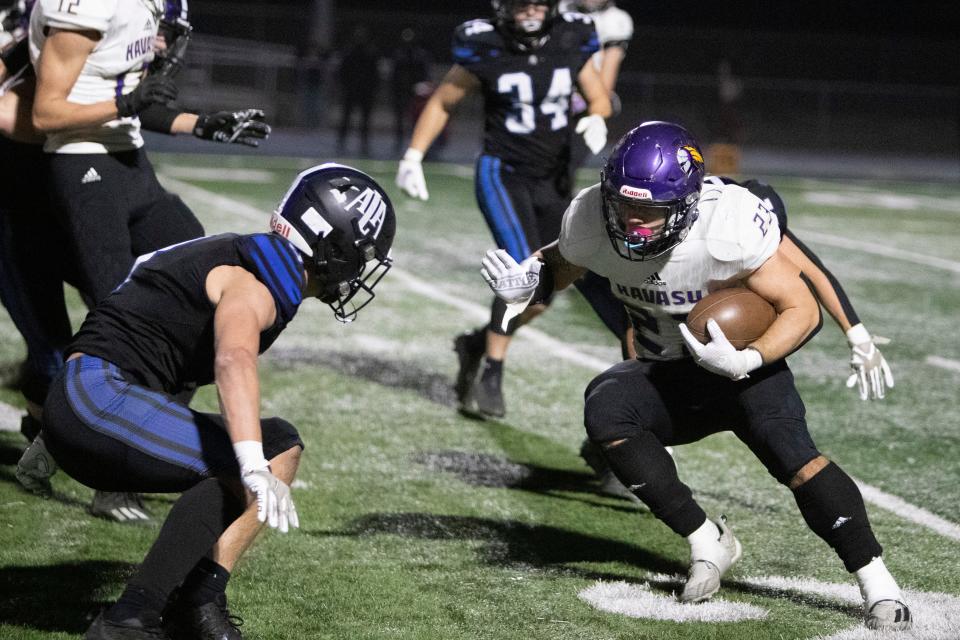 Dec. 2, 2022, Gilbert, Arizona, USA; Lake Havasu senior running back Isaac Stopke (23) looks to avoid a tackle made by ALA Gilbert North. Mandatory credit: Angelina Steel/ The Republic