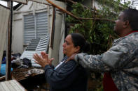 A woman reacts while she looks at the damages in the house of her mother after the area was hit by Hurricane Maria in Guayama, Puerto Rico September 20, 2017. REUTERS/Carlos Garcia Rawlins