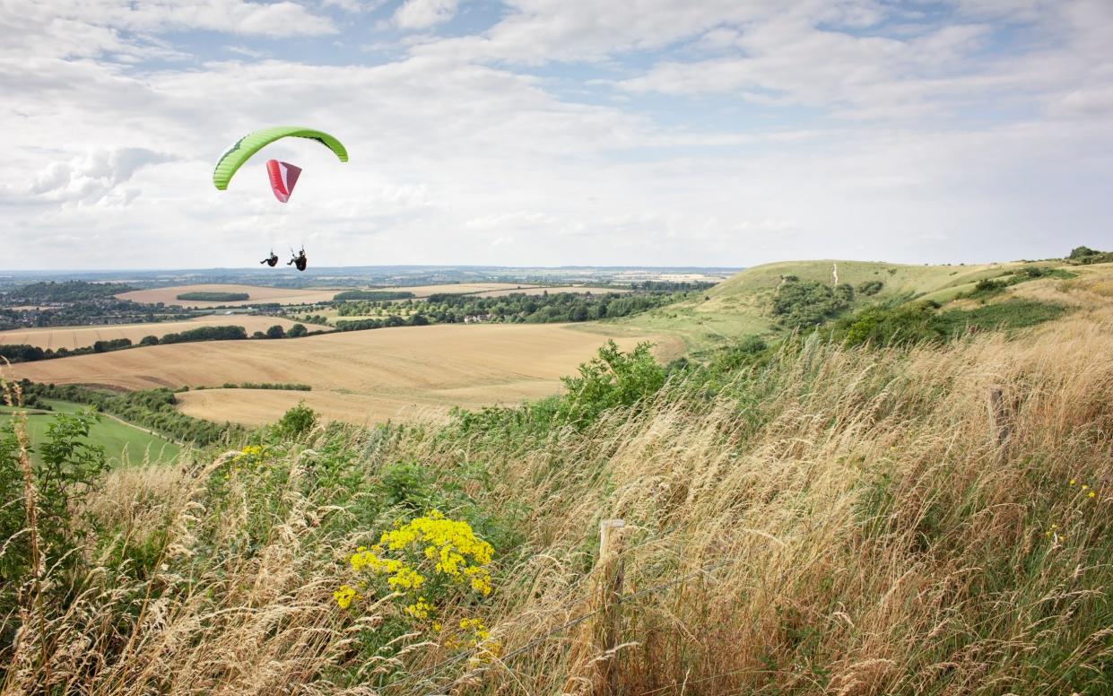 Hang gliders fly over Dunstable Downs in the Chilterns