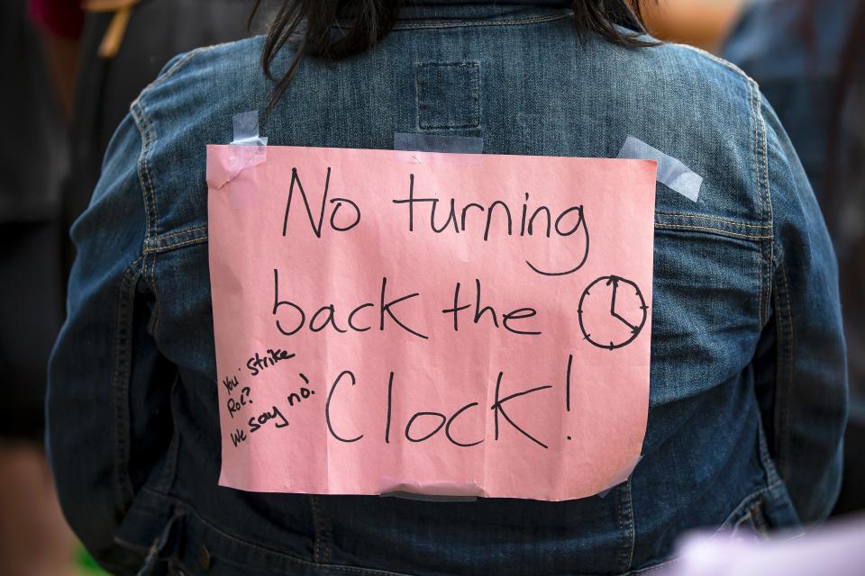 A sign taped to the back of a woman's jacket reads during an abortion rights protest held at the Arizona Capitol in Phoenix on May 3, 2022.