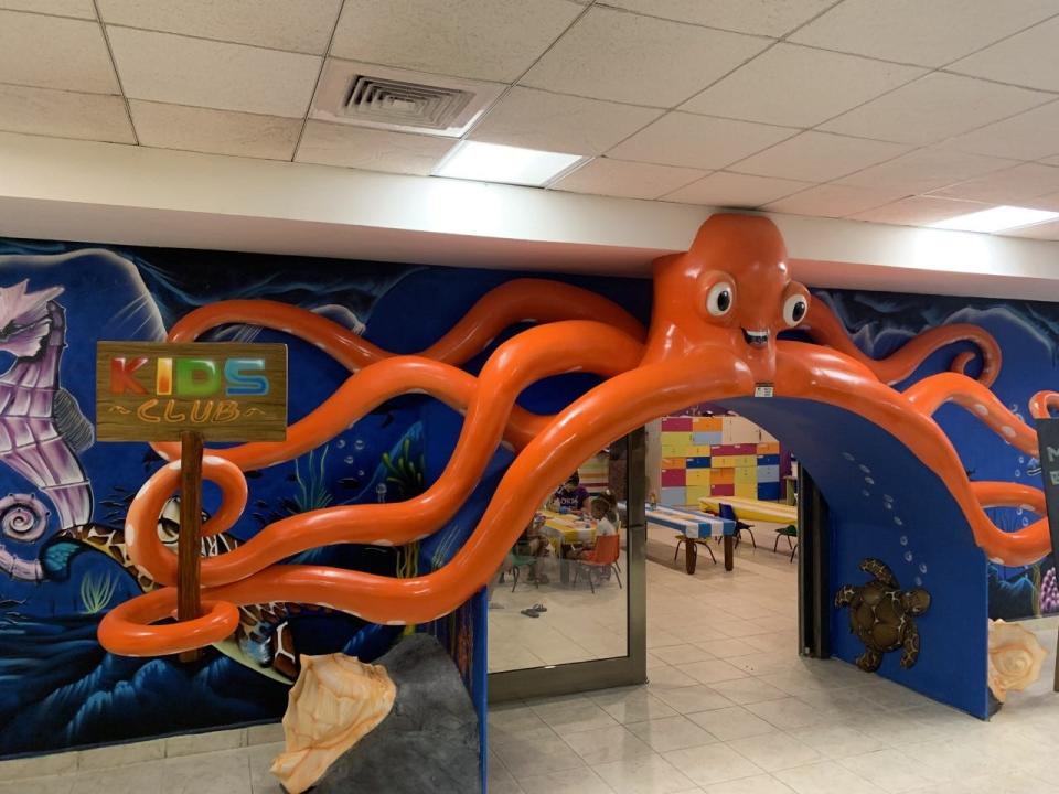 The colorful entrance to a hotel kids club with a large orange octopus over the door.