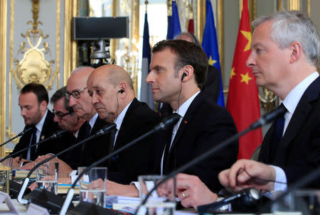 French President Emmanuel Macron, French Foreign Minister Jean-Yves Le Drian and Finance Minister Bruno Le Maire attend a meeting with Chinese President Xi Jinping (not seen) at the Elysee Palace in Paris, France, March 25, 2019. REUTERS/Gonzalo Fuentes/Pool