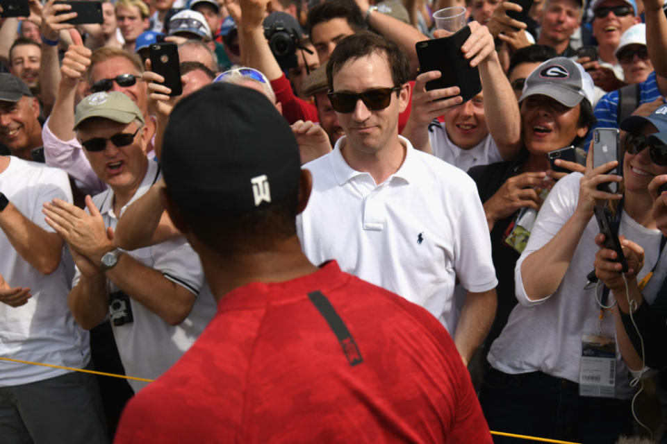 Tiger Woods meets a fan he hit with a ball. (Getty)