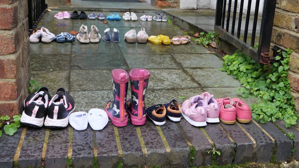 Pro-Palestinian demonstrators leave a display of children's shoes outside the Starmers' home in north London earlier this year. - Youth Demand/PA