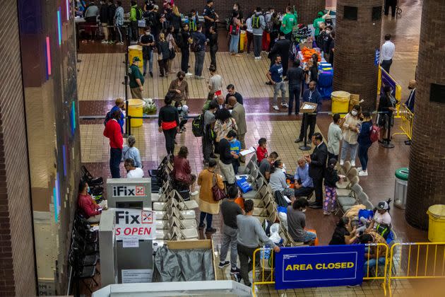 Asylum seekers fill out paper work and receive shoes and other items inside the Port Authority bus terminal in New York on Sept. 9, 2022.