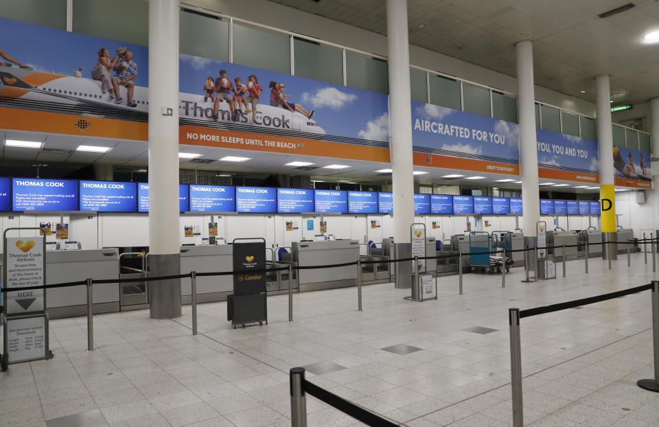 Empty Thomas Cook check-in desk in Gatwick Airport, England Monday, Sept. 23, 2019. British tour company Thomas Cook collapsed early Monday after failing to secure emergency funding, leaving tens of thousands of vacationers stranded abroad. (AP Photo/Alastair Grant)