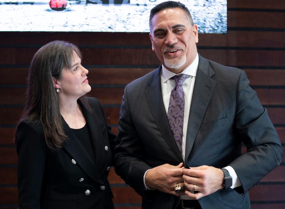 Lipscomb University president Candace McQueen (left) chats with new Lipscomb Academy head football coach Kevin Mawae on Tuesday.