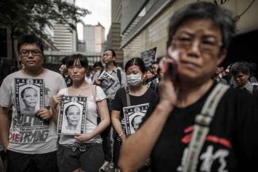 People take part in a protest for the cause of late Chinese dissident Li Wangyang in Hong Kong on June 10. Hong Kong's incoming leader Leung Chun-ying observed a minute's silence Saturday in memory of Li in the latest display of concern in the southern Chinese city over his death