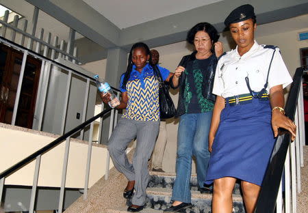 Yang Feng Glan (C), who is suspected of trafficking ivory, is escorted by police officers as she leaves the Kisutu Residents Magistrate Court in Dar es Salaam, Tanzania, October 7, 2015. REUTERS/Stringer