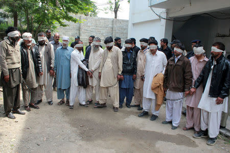 Members of a tribal council accused of ordering the burning death of a 16-year-old girl are shown to the media after they were arrested by police in Donga Gali, outside Abbottabad, Pakistan May 5, 2016. REUTERS/Online News