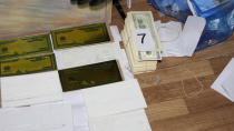 In this photo provided by Bulgaria's Interior Ministry on Tuesday, March 16, 2021, items used to print counterfeit money at a printing office in a university, in Sofia. Bulgarian authorities say they have seized high-quality forged banknotes produced at a printing office in a university in the Bulgarian capital. In a joint operation with U.S. Secret Service, Bulgarian police detained two people and seized a printing machine and equipment for printing money, along with large amounts of counterfeit U.S. dollar and euro notes. (Bulgarian Interior Ministry via AP)