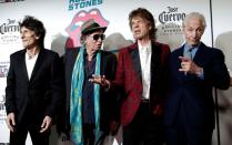 The Rolling Stones (L-R) Ronnie Wood, Keith Richards, Mick Jagger and Charlie Watts pose as they arrive for the opening of the new exhibit "Exhibitionism: The Rolling Stones" in the Manhattan borough of New York City