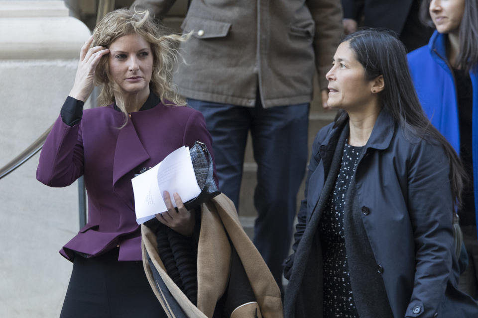 Summer Zervos, left, leaves New York state appellate court with here attorney Mariann Wang, Thursday, Oct. 18, 2018, in New York. President Donald Trump's lawyers hope to persuade an appeals court to dismiss or delay Zervos' claim that he defamed her by calling her a liar after she accused him of unwanted kissing and groping. (AP Photo/Mary Altaffer)