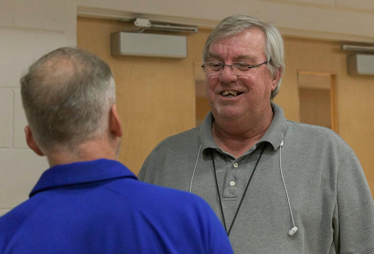 Daily Commercial sports reporter Frank Jolley speaks to MDCA boys basketball coach Steven Hayes after an MDCA basketball game in January. Jolley is retiring on July 1 after 19 years at the Daily Commercial and more than 40 as a reporter.