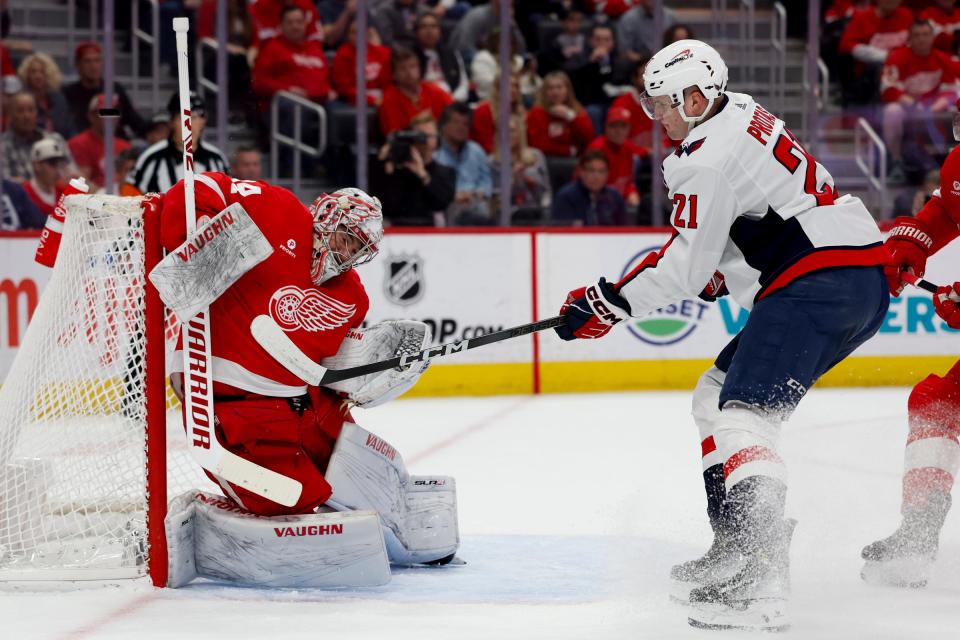 Red Wings goaltender Alex Lyon makes a save on Capitals center Aliaksei Protas in the first period on Tuesday, April 9, 2024, at Little Caesars Arena.