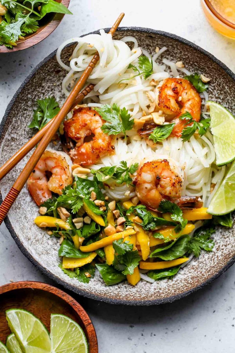 A noodle salad with mangos and shrimp.