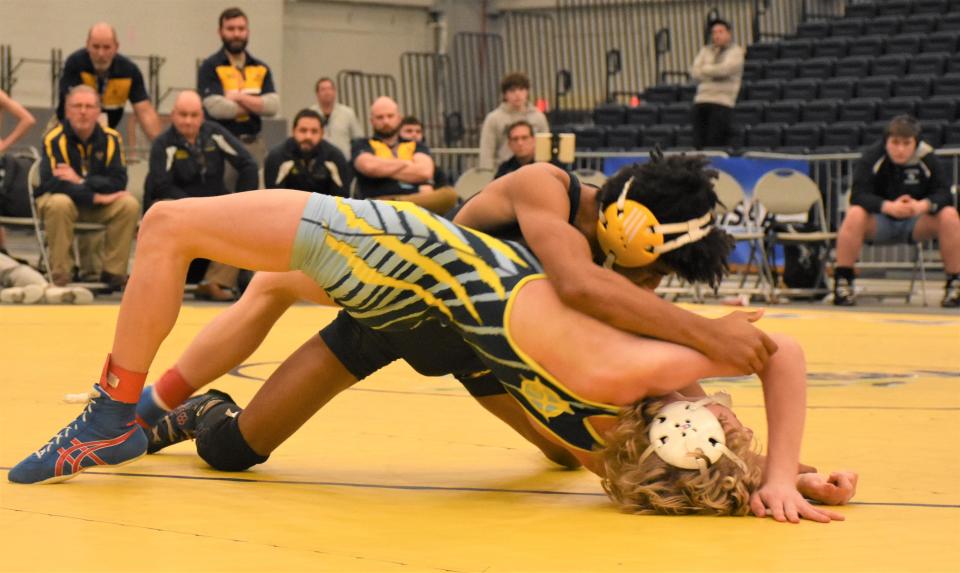 Central Valley Academy's Gene Edwards (foreground) arches his back to keep his shoulders off the mat against Jayden Duncanson of Tioga at New York's state dual meet championship tournament.