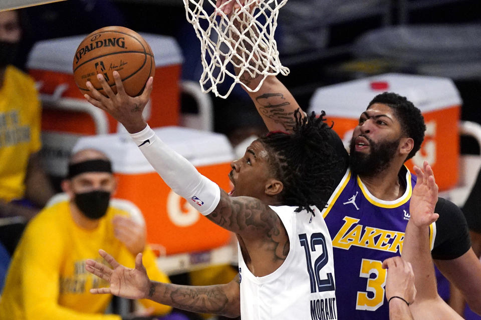 Memphis Grizzlies guard Ja Morant, left, shoots as Los Angeles Lakers forward Anthony Davis defends during the first half of an NBA basketball game Friday, Feb. 12, 2021, in Los Angeles. (AP Photo/Mark J. Terrill)