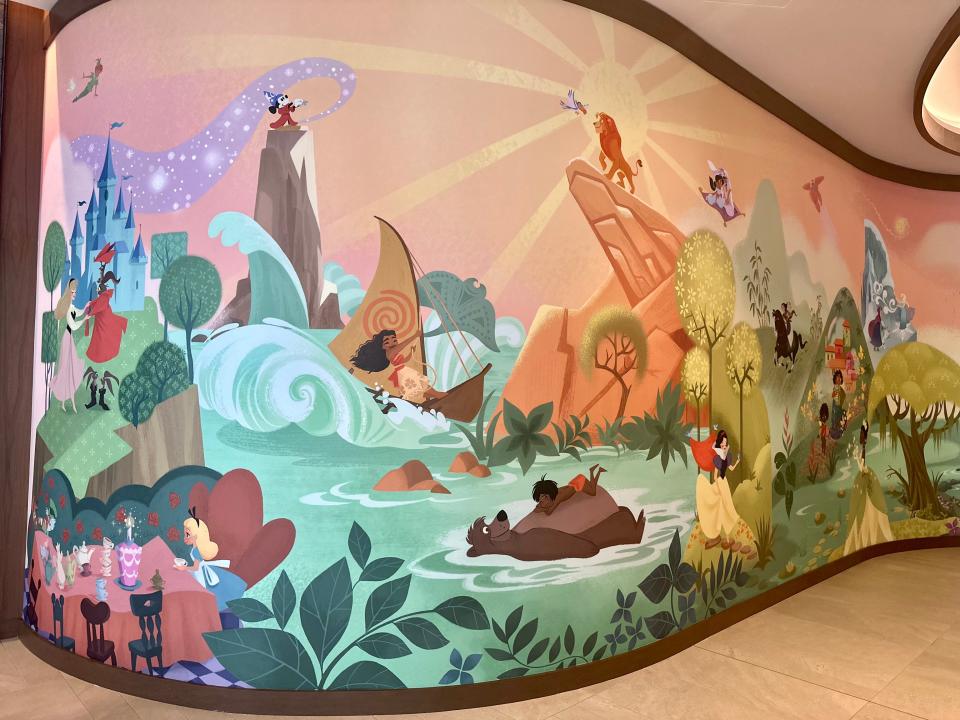 Colorful Disney mural on curved wall in Disneyland Villas lobby