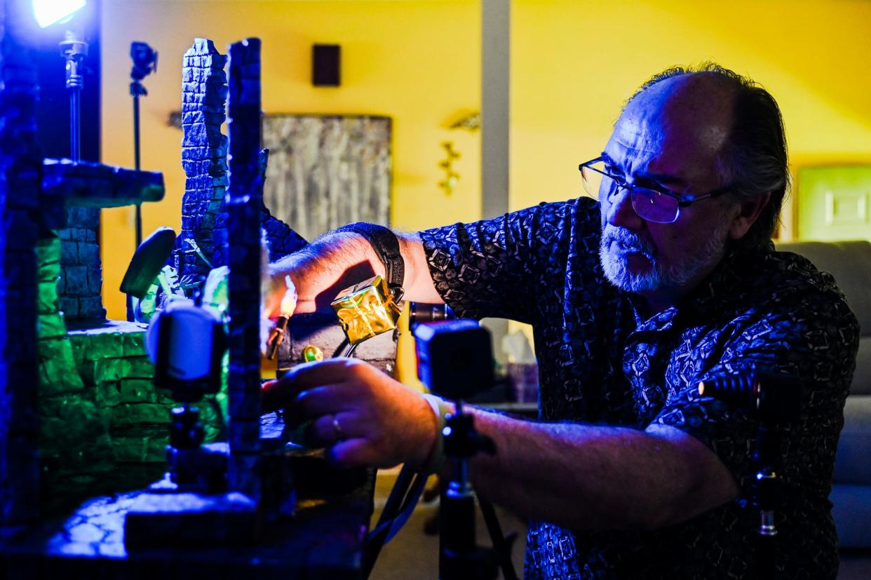 Kevin Epling sets up action figures in one of his toy photography art sets Wednesday, May 24, 2023, at his home in East Lansing.