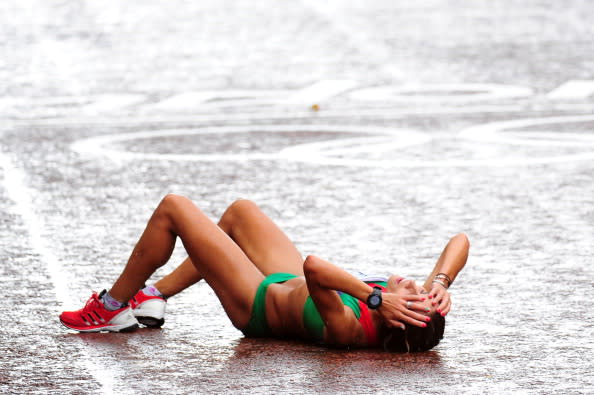 Ana Dulce Felix of Portugal lies on the ground after crossing the finish line during the Women's Marathon on Day 9 of the London 2012 Olympic Games at The Mall on August 5, 2012 in London, England. (Photo by Stu Forster/Getty Images)