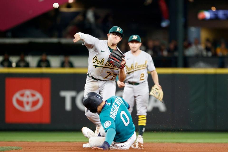 SEATTLE, WASHINGTON - SEPTEMBER 30: Jonah Bride #77 of the Oakland Athletics turns a double play over Sam Haggerty #0 of the Seattle Mariners during the fifth inning at T-Mobile Park on September 30, 2022 in Seattle, Washington. (Photo by Steph Chambers/Getty Images)