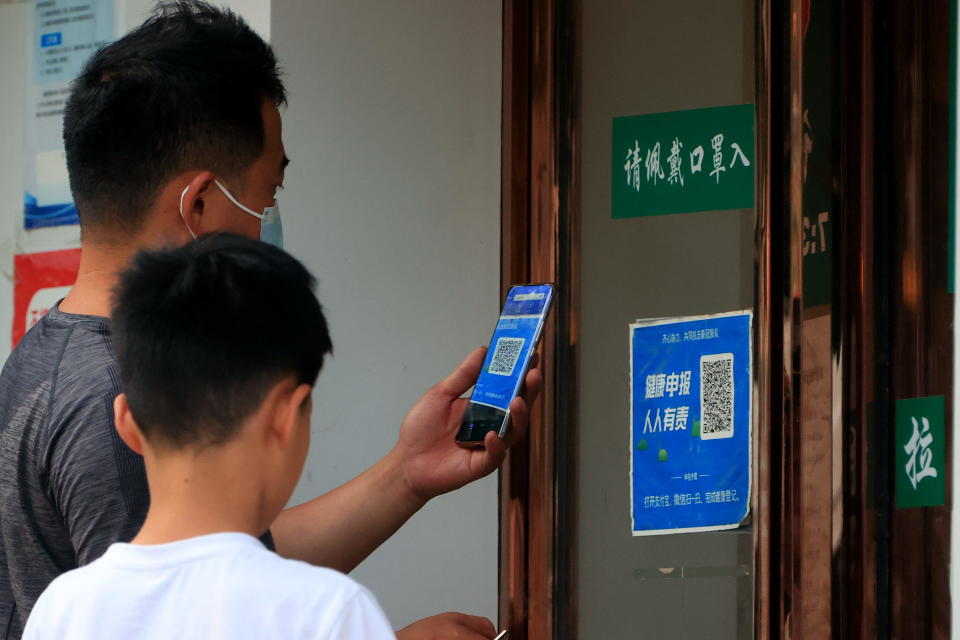 A man scans a QR code to present his COVID-19 risk code before entering a shop in Zhengzhou city, in central China's Henan province, June 17, 2022. / Credit: SHANG JI/ Feature China/Future Publishing/Getty