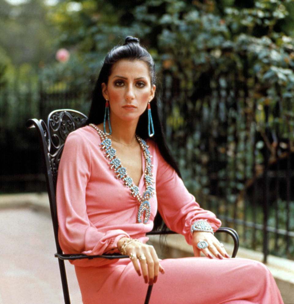 <p>Posing at the home she shared with Sonny, the singer looked stunning in a beaded pink maxi dress paired with matching earrings. <i>[Photo: Rex]</i></p>