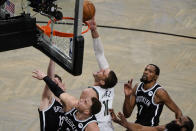 Milwaukee Bucks' Brook Lopez (11) shoots over Brooklyn Nets' Blake Griffin, front left, Kevin Durant (7) and James Harden, right, during the second half of Game 7 of a second-round NBA basketball playoff series Saturday, June 19, 2021, in New York. (AP Photo/Frank Franklin II)