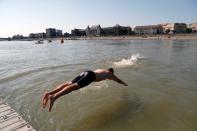 Participants swim across the Danube River during the Budapest Urban Games in Budapest