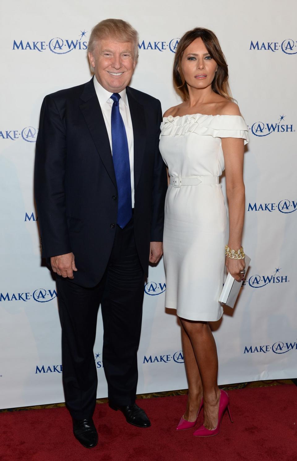 <p>Going back to white, Melania worked a belted dress and patent pink stilettos to attend a charity gala with her husband, Donald Trump. <i>[Photo: Getty]</i> </p>