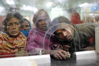 Passengers wait to purchase tickets at a reservation counter in Allahabad, India.