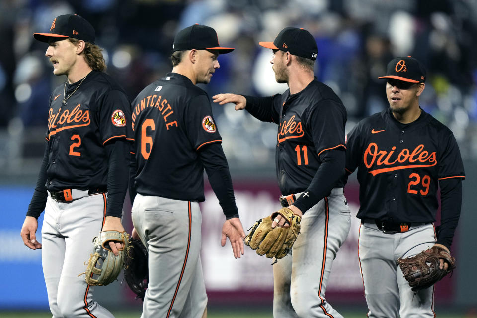 Baltimore Orioles' Gunnar Henderson (2), Ryan Mountcastle (6), Jordan Westburg (11) and Ramon Urias (29) celebrate after their baseball game against the Kansas City Royals Saturday, April 20, 2024, in Kansas City, Mo. The Orioles won 9-7. (AP Photo/Charlie Riedel)