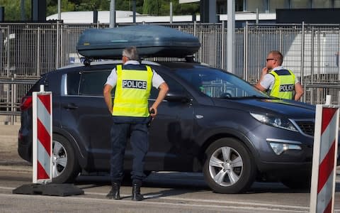 French police officers control vehicles coming across the border from Spain  - Credit: RAYMOND ROIG/AFP