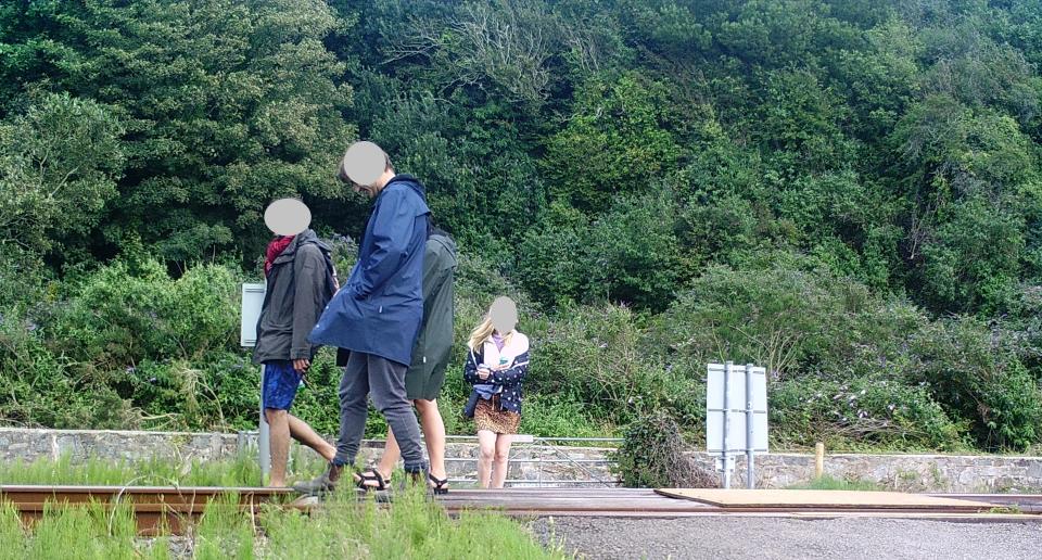 People walking across railway lines in Harlech, Wales. (Network Rail)