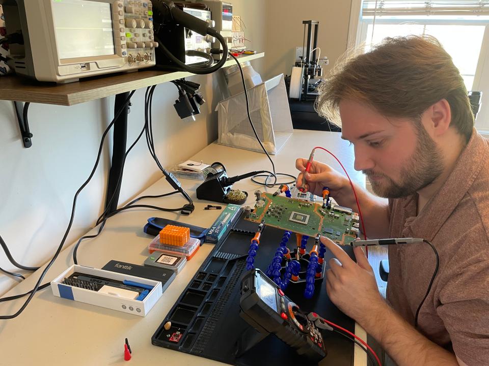 Adam Foshie looks for a problem in a vintage video game. It was during the 2020 pandemic when Foshie and Samantha Malone, both graduate students at the time, got into a bit of a side hustle repairing video games for people or finding broken games, restoring them and then selling them.