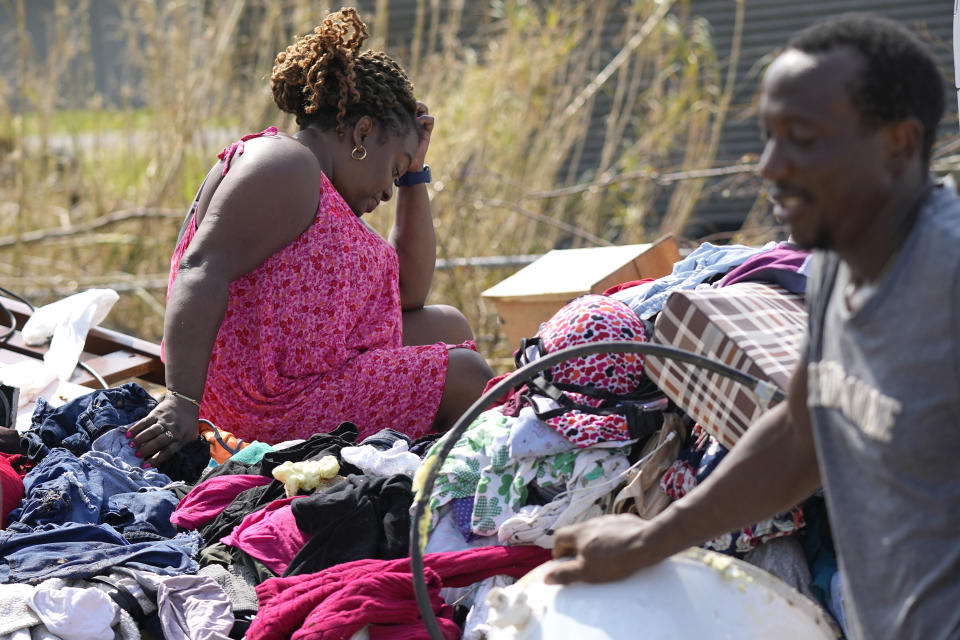 Cruz Palma pauses while salvaging belongings from her destroyed home in the aftermath of Hurricane Ida, Thursday, Sept. 2, 2021, in Golden Meadow, La. (AP Photo/David J. Phillip)