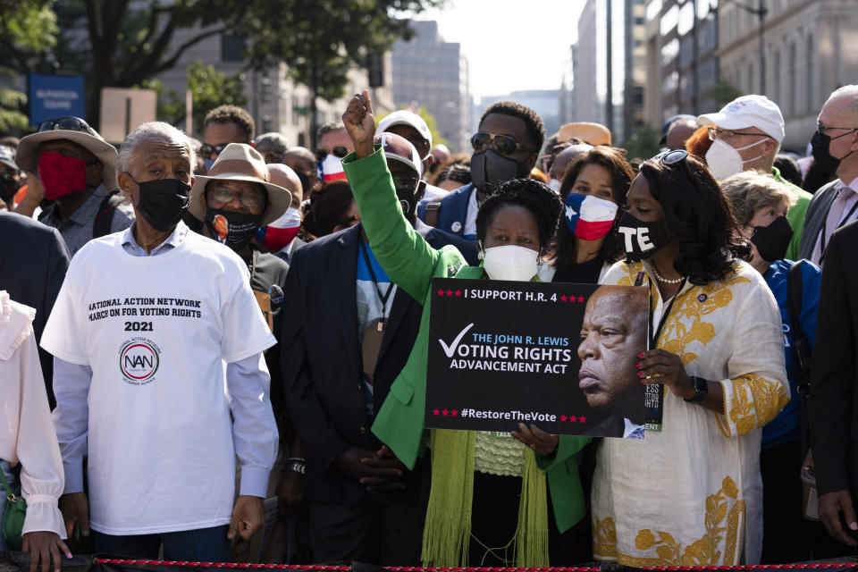 From left, the Rev. Al Sharpton, Sheila Jackson Lee, D-Texas, and Rep. Terri Sewell, D-Ala., attend a march for voting rights, marking the 58th anniversary of the March on Washington, Saturday, Aug. 28, 2021, in Washington. Hundreds of thousands of voting rights advocates rallied across the country Saturday to call for sweeping protections against a further erosion of the Voting Rights Act of 1965. (AP Photo/Jose Luis Magana)