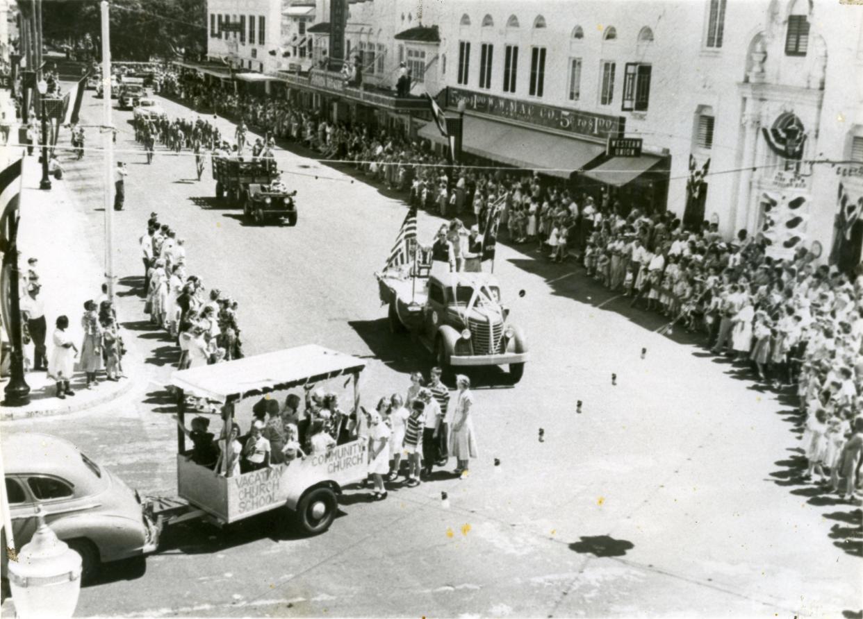 A crowd watches the Fourth of July Parade in downtown Vero Beach at the intersection of 20th Street and 14th Avenue, circa 1940s. Citrus Bank, Western Union, and the Florida Theatre are among the visible businesses. 