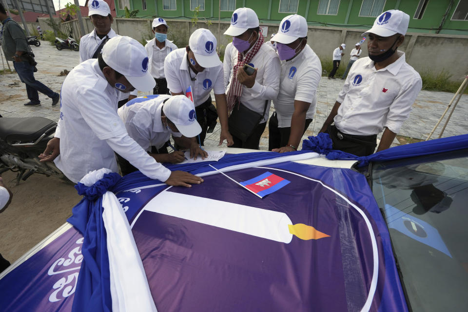 Candlelight Party supporters register on the participant lists near their party's logo before their march during an election campaign for the June 5 communal elections in Phnom Penh, Cambodia, Saturday, May 21, 2022. Cambodia's National Election Committee on Monday, May 15, 2023, refused to register the Candlelight Party, the country's sole credible challenger to the governing Cambodian People's Party, for participation in this July election, saying it had failed to provide the necessary documents. (AP Photo/Heng Sinith)