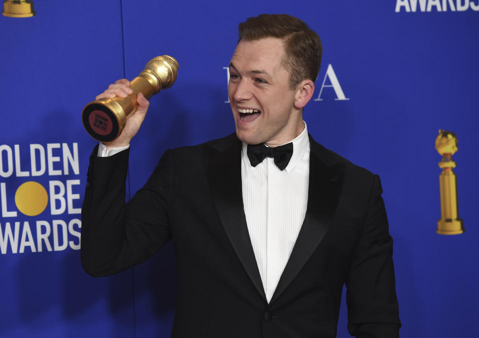 Taron Egerton poses in the press room with the award for best performance by an actor in a motion picture, musical or comedy, for "Rocketman" at the 77th annual Golden Globe Awards at the Beverly Hilton Hotel on Sunday, Jan. 5, 2020, in Beverly Hills, Calif. (AP Photo/Chris Pizzello)