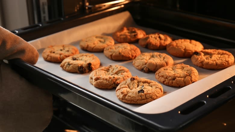 Pulling cookie sheet from oven