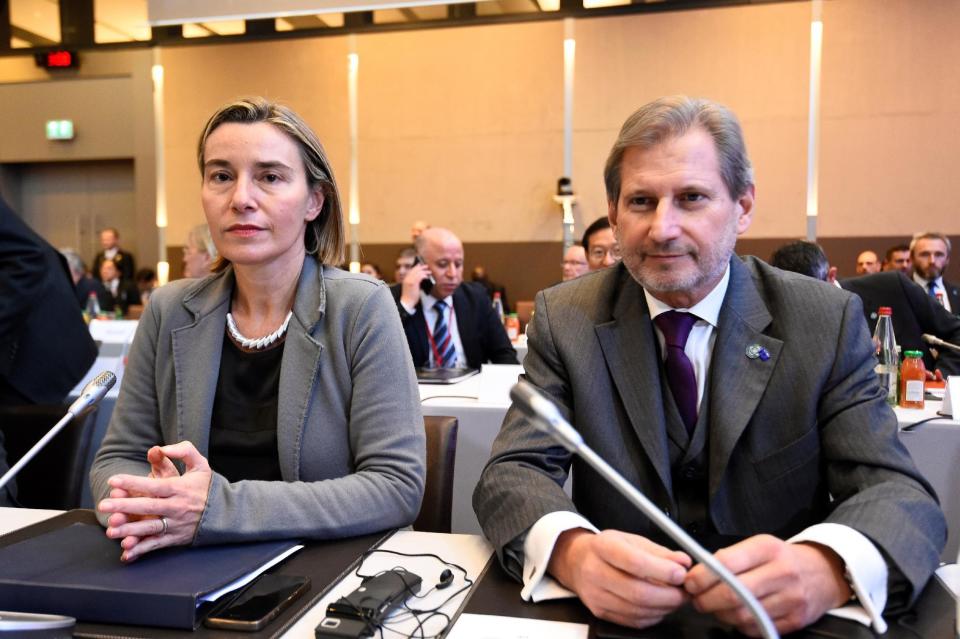 European Union Foreign Policy Chief Federica Mogherini, left, and European Union Commissioner Johannes Hahn attend a Mideast peace conference in Paris, Sunday, Jan. 15, 2017. Fearing a new eruption of violence in the Middle East, more than 70 world diplomats gathered in Paris on Sunday to push for renewed peace talks that would lead to a Palestinian state. (Bertrand Guay/Pool Photo via AP)