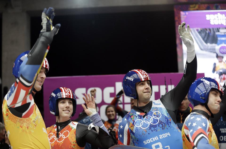 The United States team from left to right, Christian Niccum, Erin Hamlin, Christopher Mazdzer and Jayson Terdiman wave to the crowd after the luge team relay competition at the 2014 Winter Olympics, Thursday, Feb. 13, 2014, in Krasnaya Polyana, Russia. (AP Photo/Natacha Pisarenko)