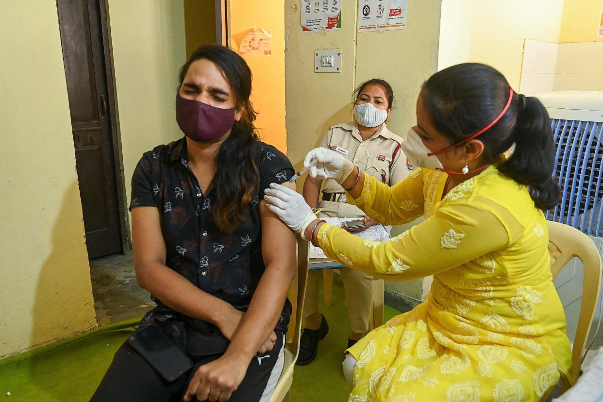 A health worker inoculates a transgender person with a dose of the Covishield vaccine against the Covid-19 coronavirus at a vaccination centre in New Delhi on 23 June, 2021 (AFP via Getty Images)