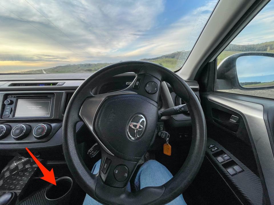 An arrow points to the cup holder where Insider's author stored her phone while driving.