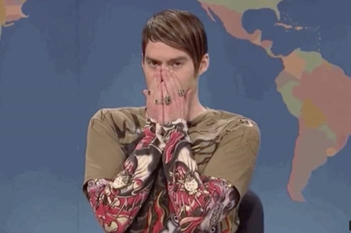 Person with hands covering mouth on SNL's Weekend Update set