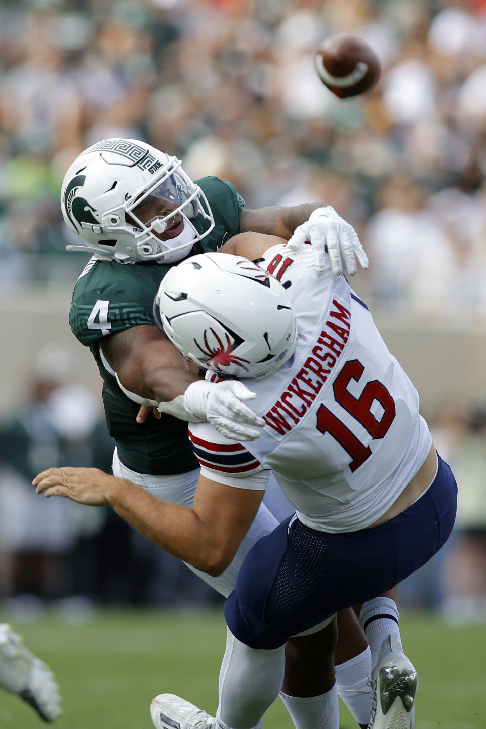 Michigan State's Jacoby Windmon, left, hits Richmond quarterback Kyle Wikersham after he releases the ball during the first half of an NCAA college football game, Saturday, Sept. 9, 2023, in East Lansing, Mich. (AP Photo/Al Goldis)